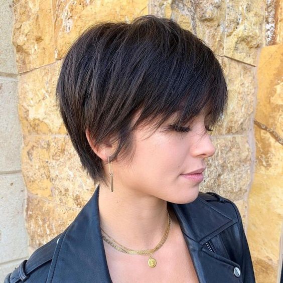 Pixie cut, Short hairstyles, Spring/summer trends, Low-maintenance, Versatility, Hair fashion, Hair color experimentation, Seasonal style, Timeless appeal, Bold statement, Facial feature enhancement, Spring fashion, Summer fashion, Haircut practicality, Haircut creativity, Chic look, Confidence, Edginess, Sophistication, Warm weather styling, Statement earrings, Trendy hats, Light, airy clothing, Floral prints, Bright colors, Big chop,